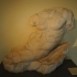 Statue of a God Lying on a Rock image