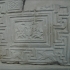 Slab decorated with a fret and animals image