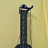 Mini electric guitar for travel. image