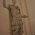 Figure in military uniform, with a modern head of Julius Caesar image